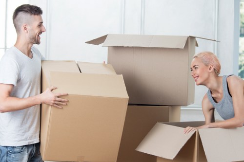 Professional movers carrying furniture in a Marylebone building